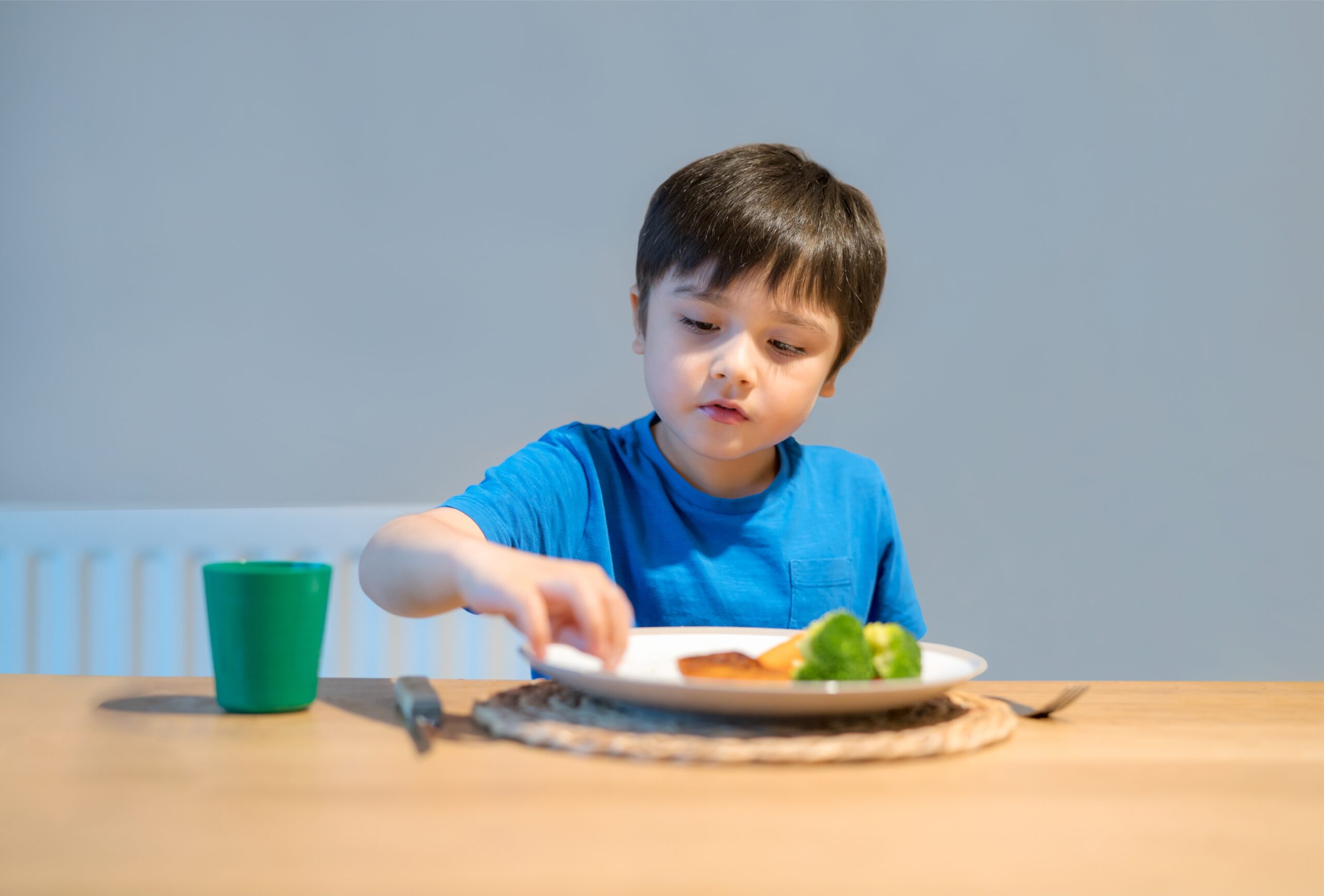 Healthy kid eating mixed vegetables salad for his meal,Child ha
