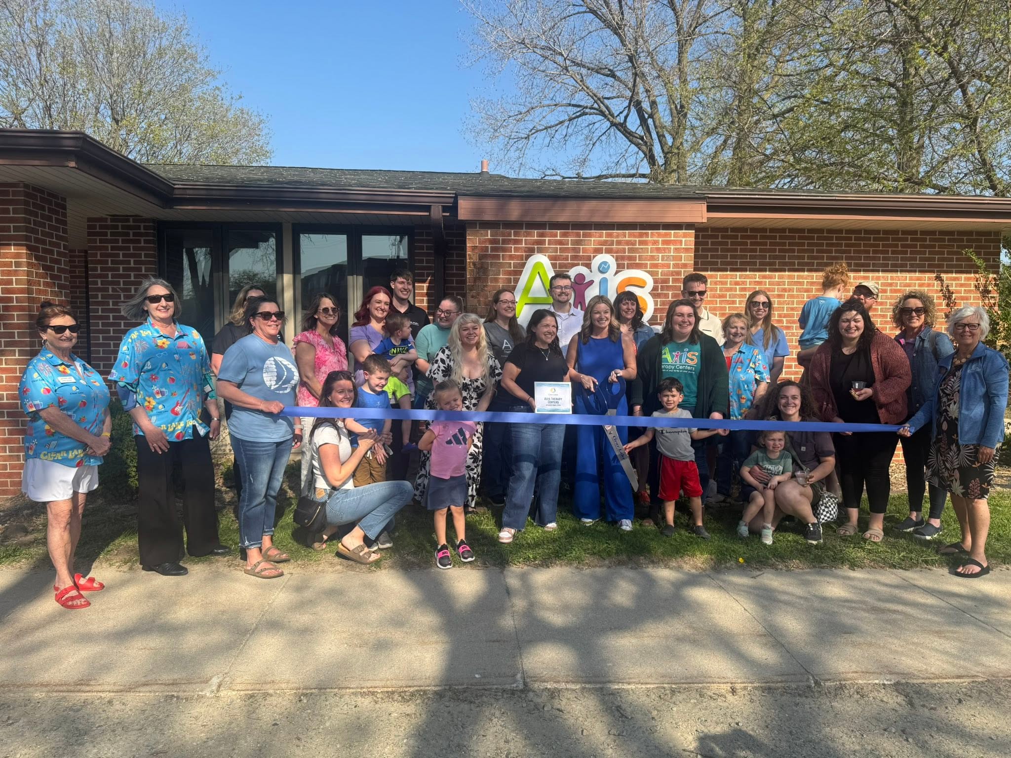 Axis Therapy Centers team and families at a ribbon-cutting event