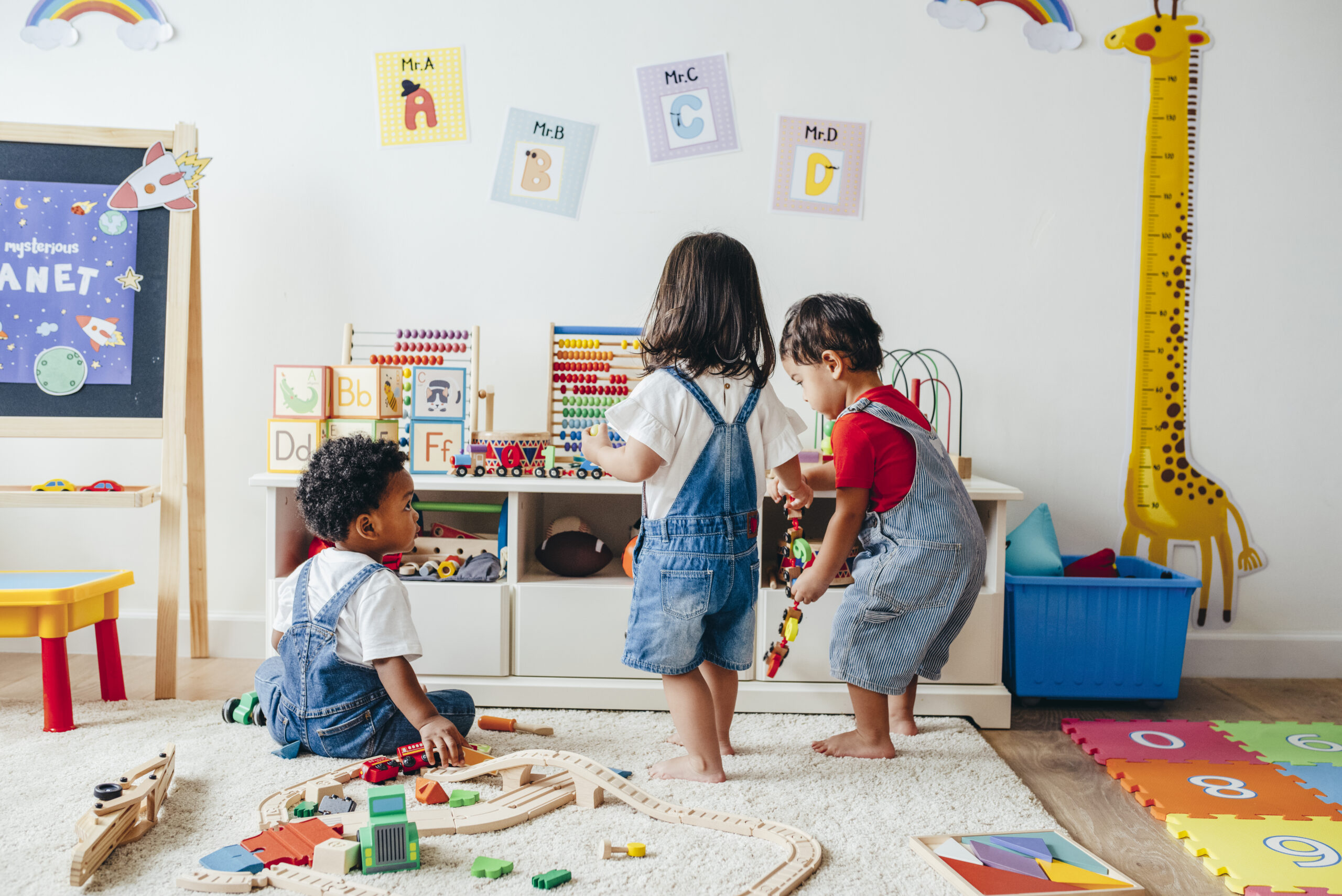 Young children enjoying in the playroom Children playing together in a bright therapy room